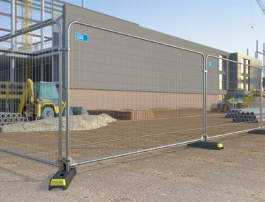 Temporary mesh construction anti-climb fencing with stabilising feet around an active building site