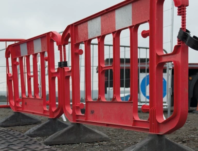 interlocking one piece red plastic barrier at a construction site